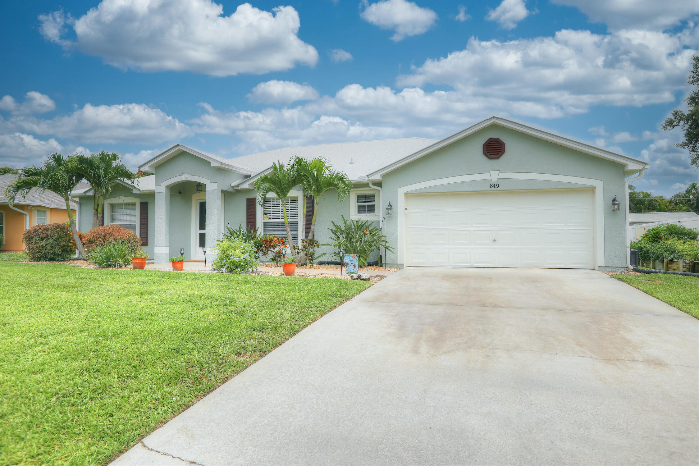 a front view of house with yard and green space