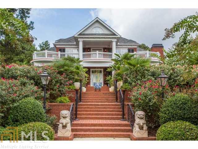 a front view of a house with plants and garden