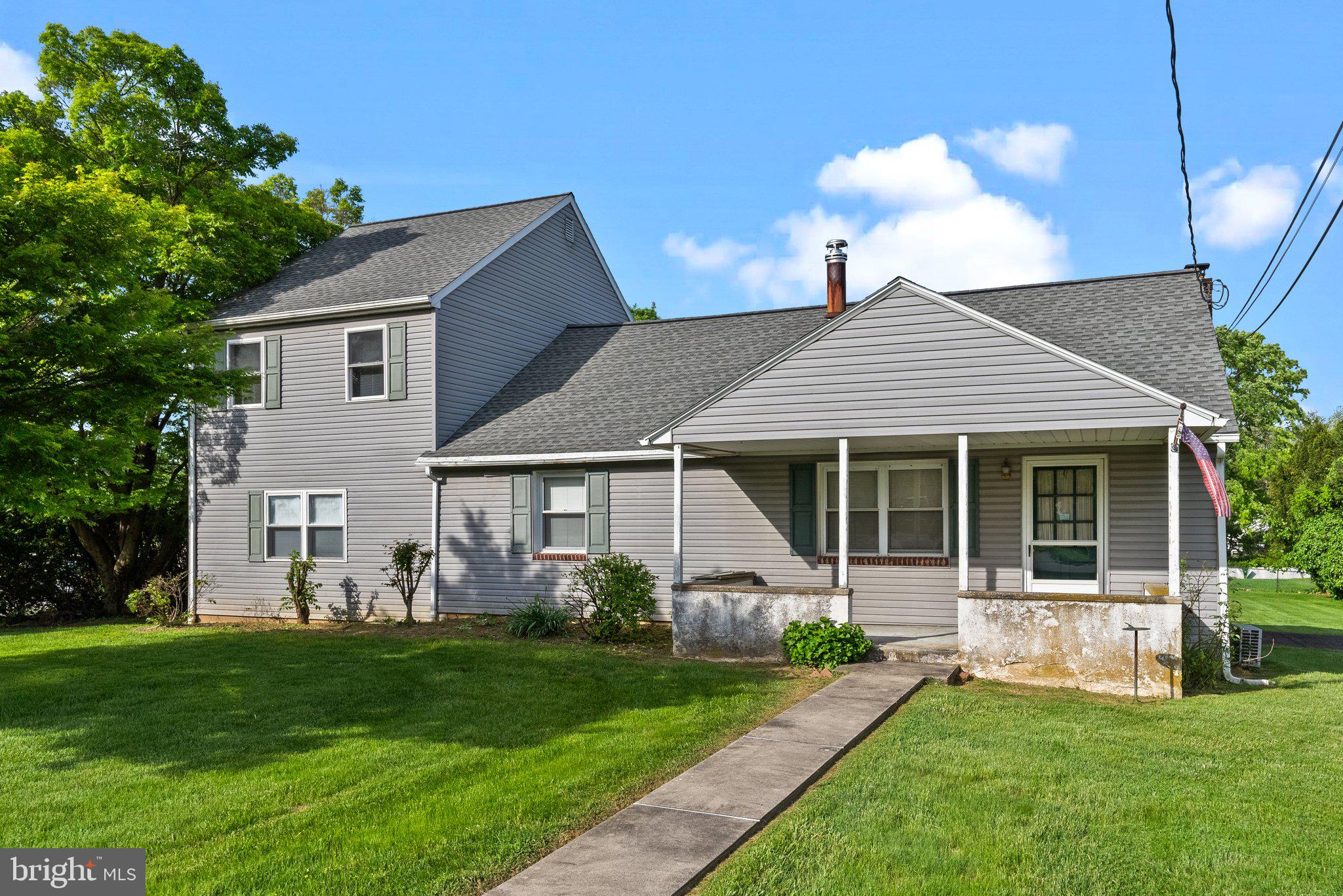 a front view of a house with a garden and yard