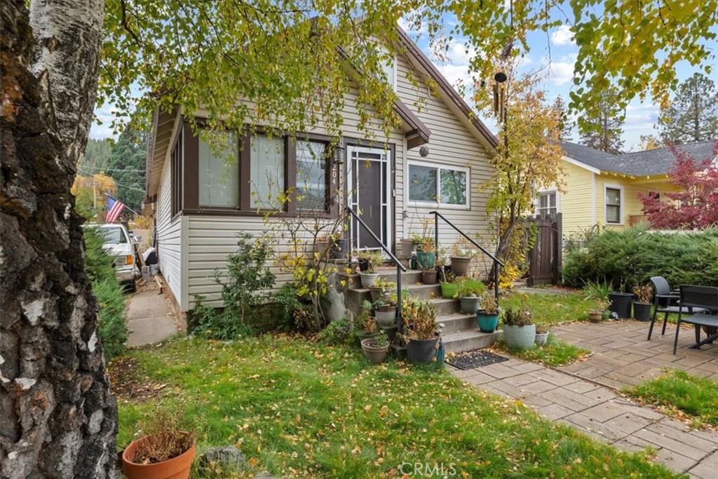 a view of backyard of house with outdoor seating and green space