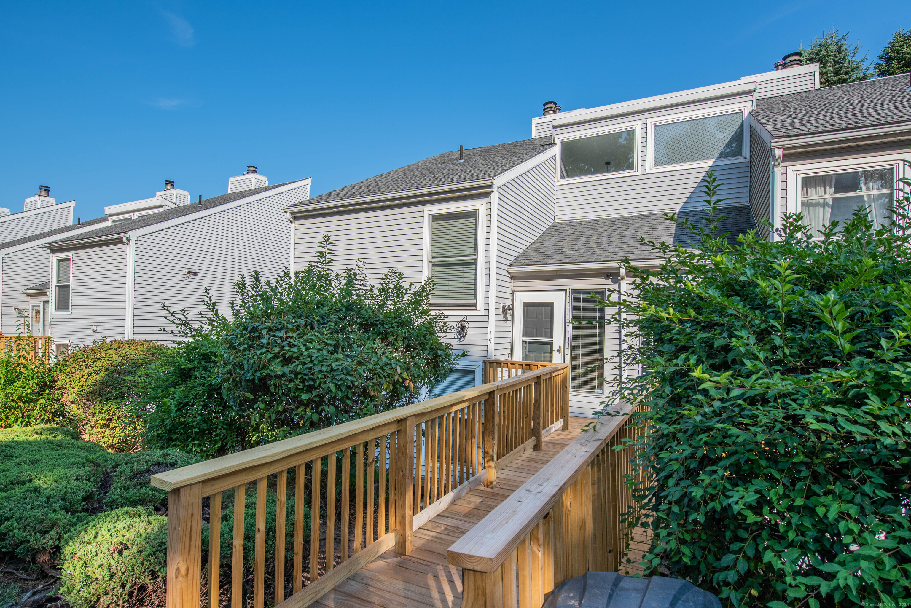 a balcony with wooden floor and fence