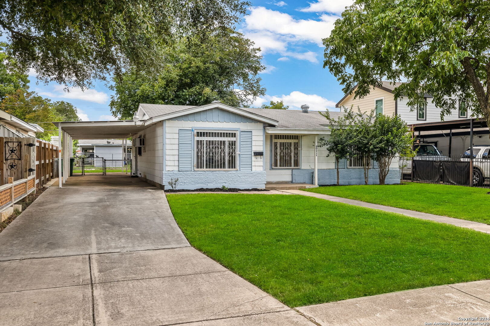 a front view of a house with a garden and yard