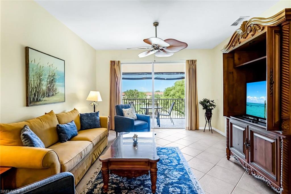 a living room with furniture a flat screen tv and a large window