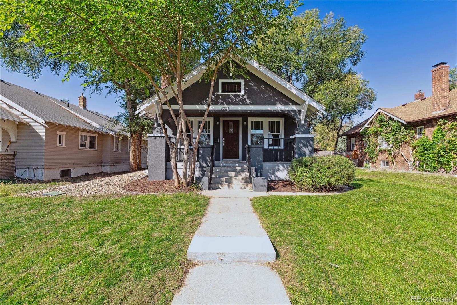 a front view of a house with yard patio and green space