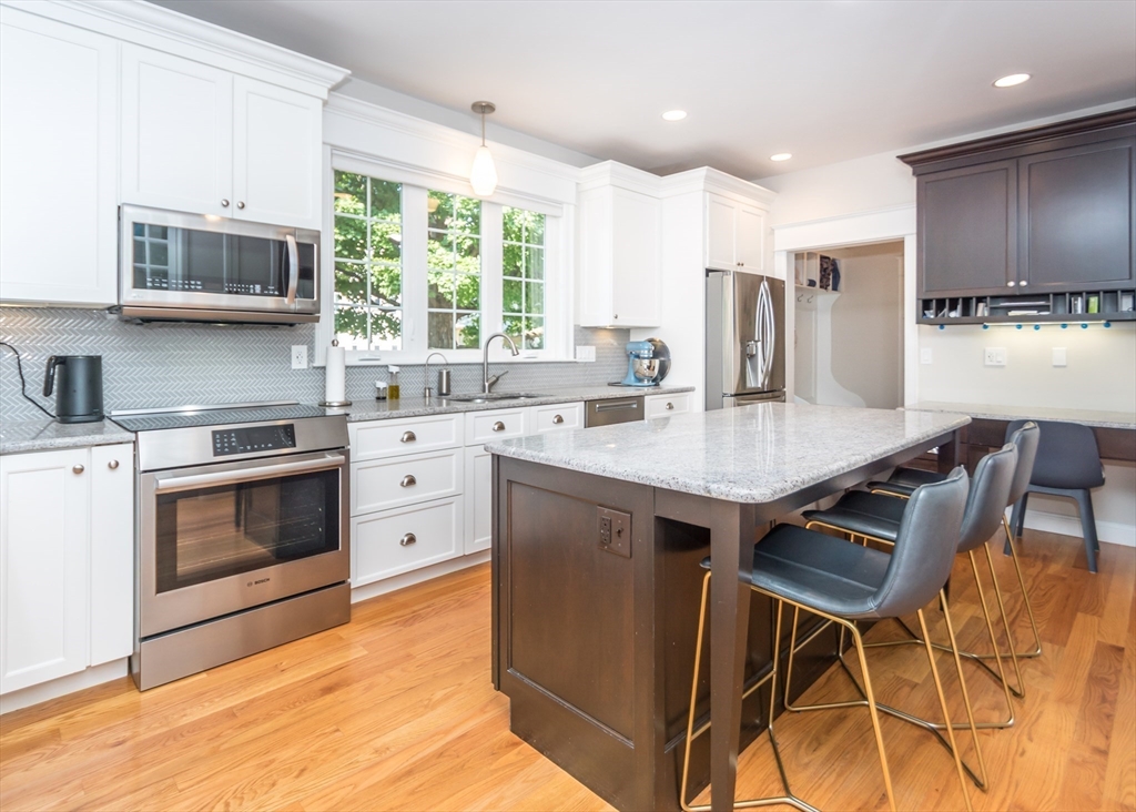 a kitchen with a stove a sink and a refrigerator