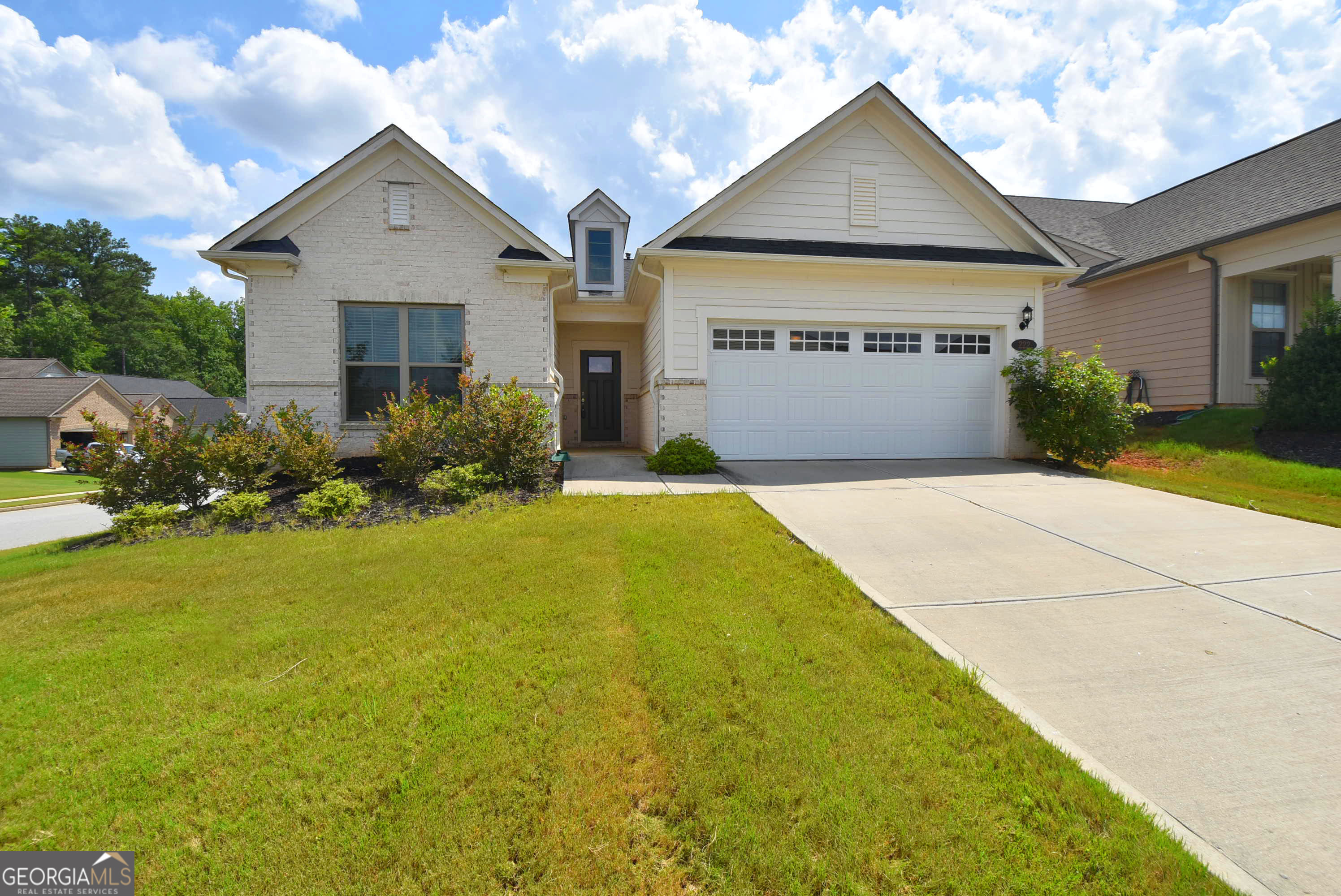 a front view of house with yard and green space