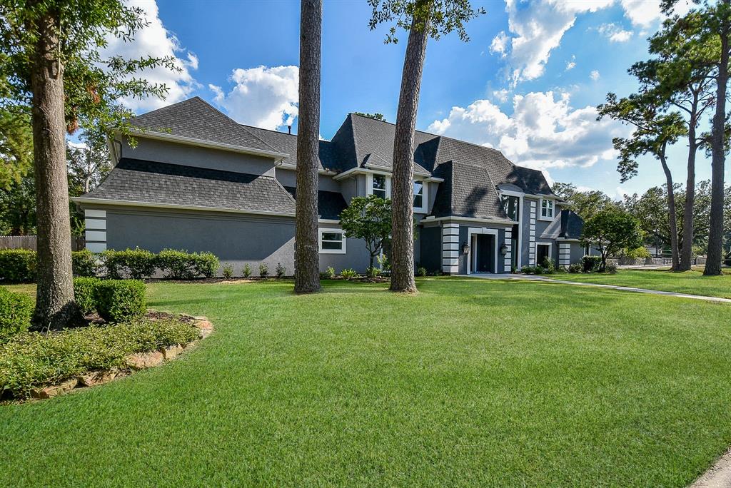 a front view of a house with a garden and yard