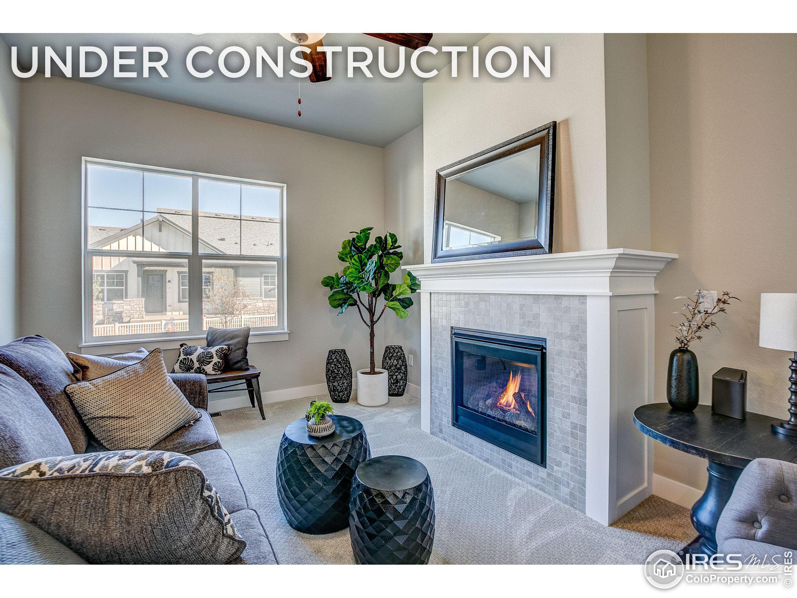 a living room with furniture a window and a fireplace