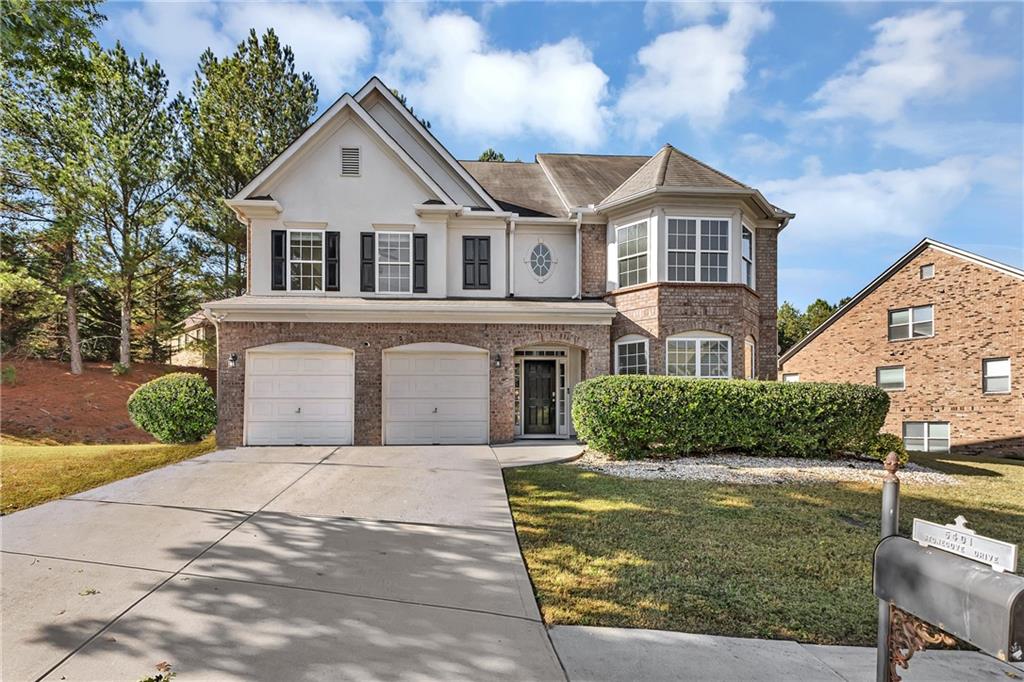 a front view of a house with a yard