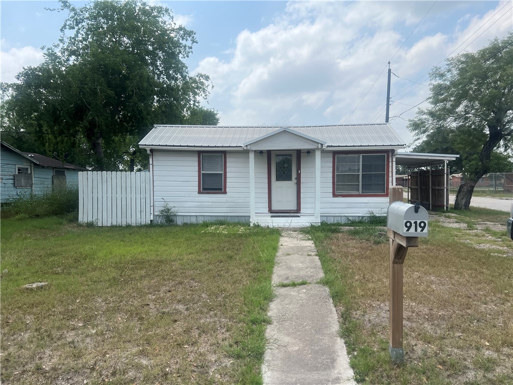 a front view of a house with a yard and porch