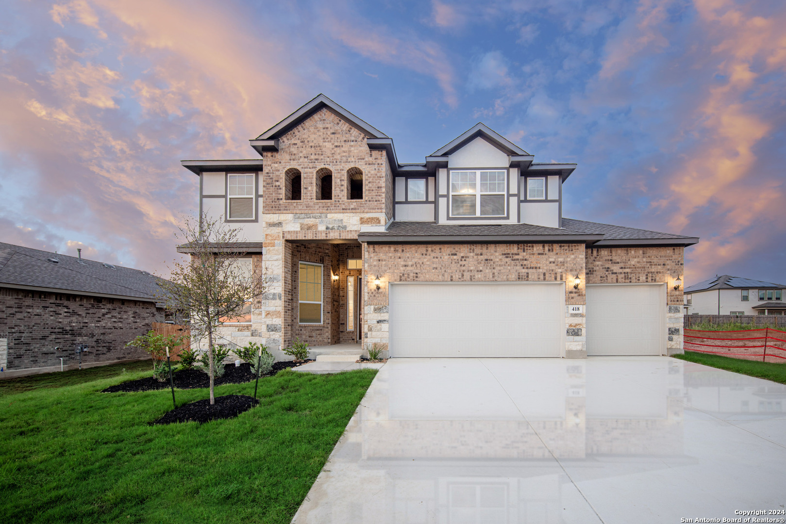 a front view of a house with a yard and garage