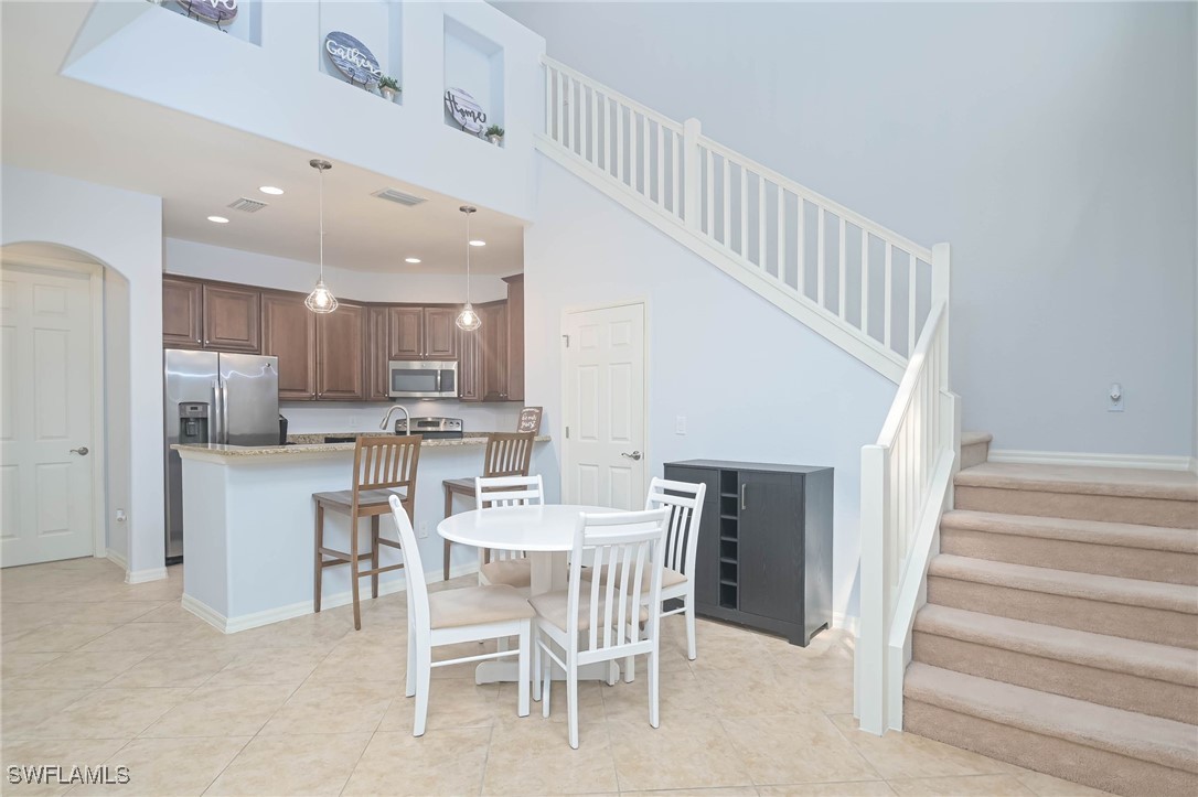 a dining room with furniture and a kitchen view