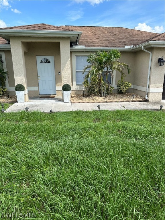 a front view of a house with a garden