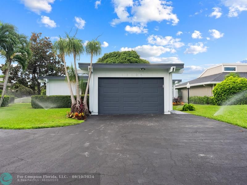 a view of a house with a yard and garage