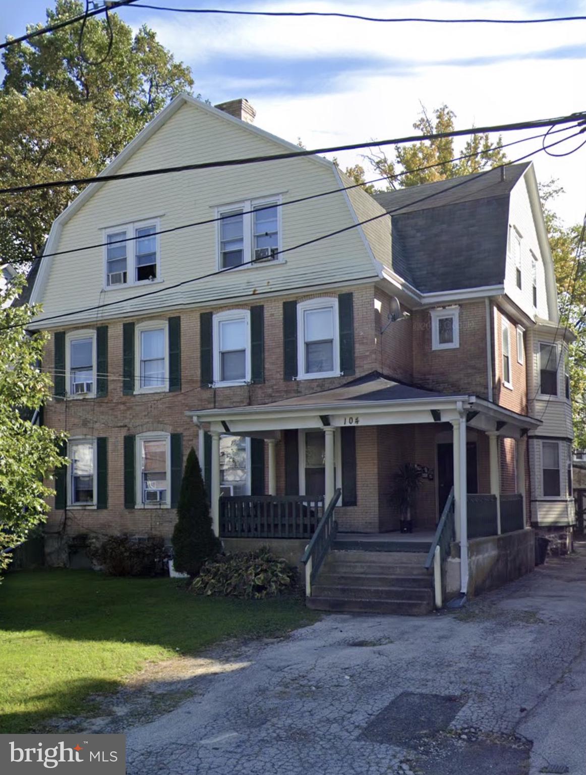 a view of a big house with a yard