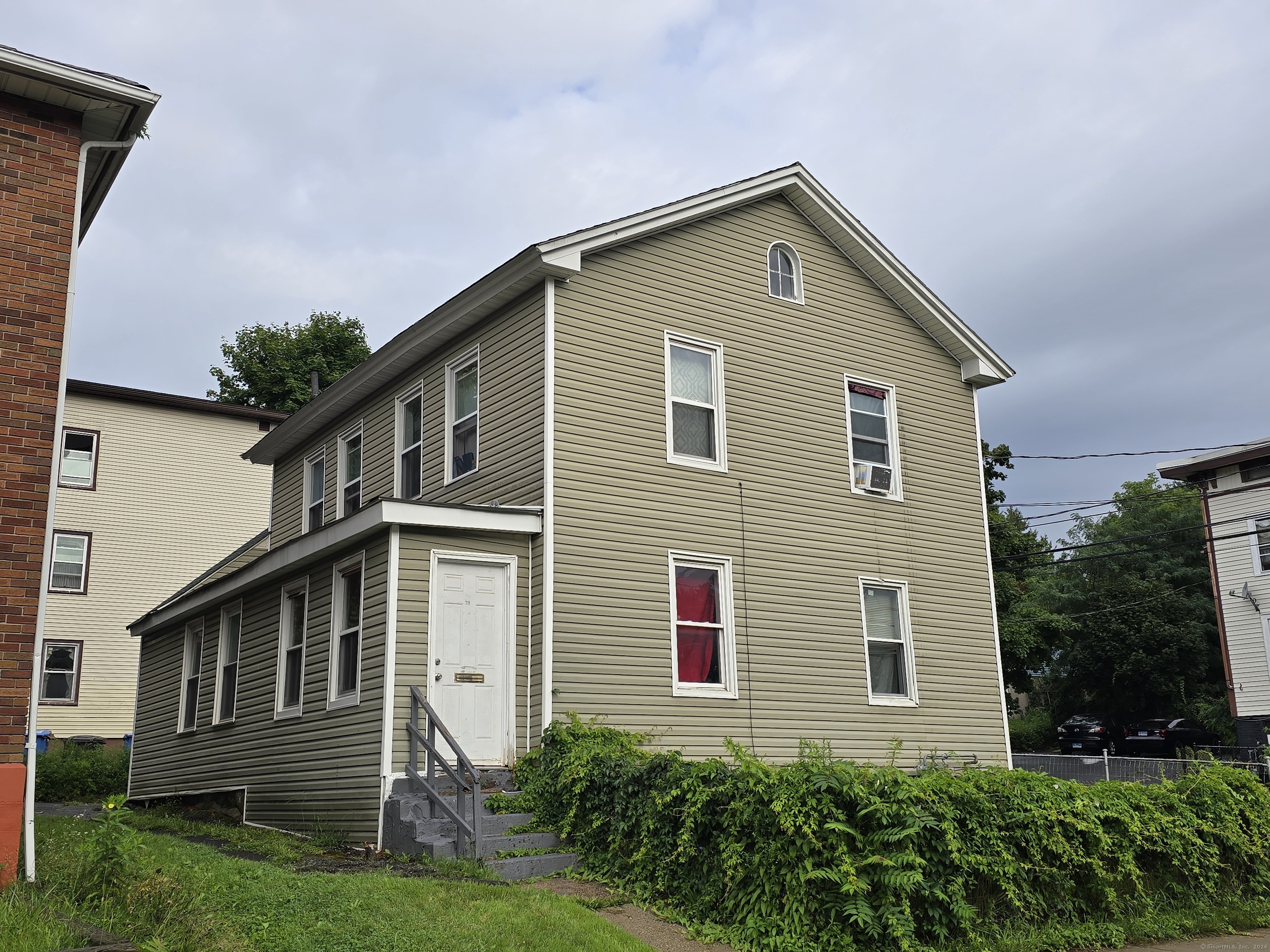 a front view of a house with garden