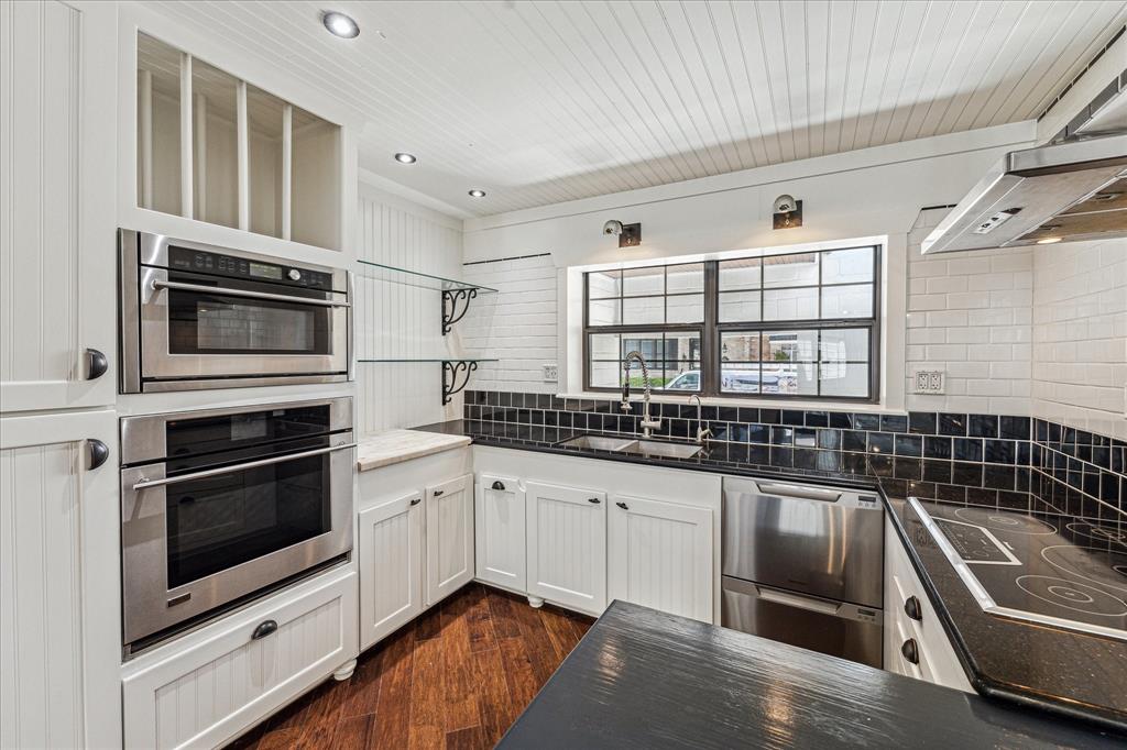 a kitchen with granite countertop a stove and a sink