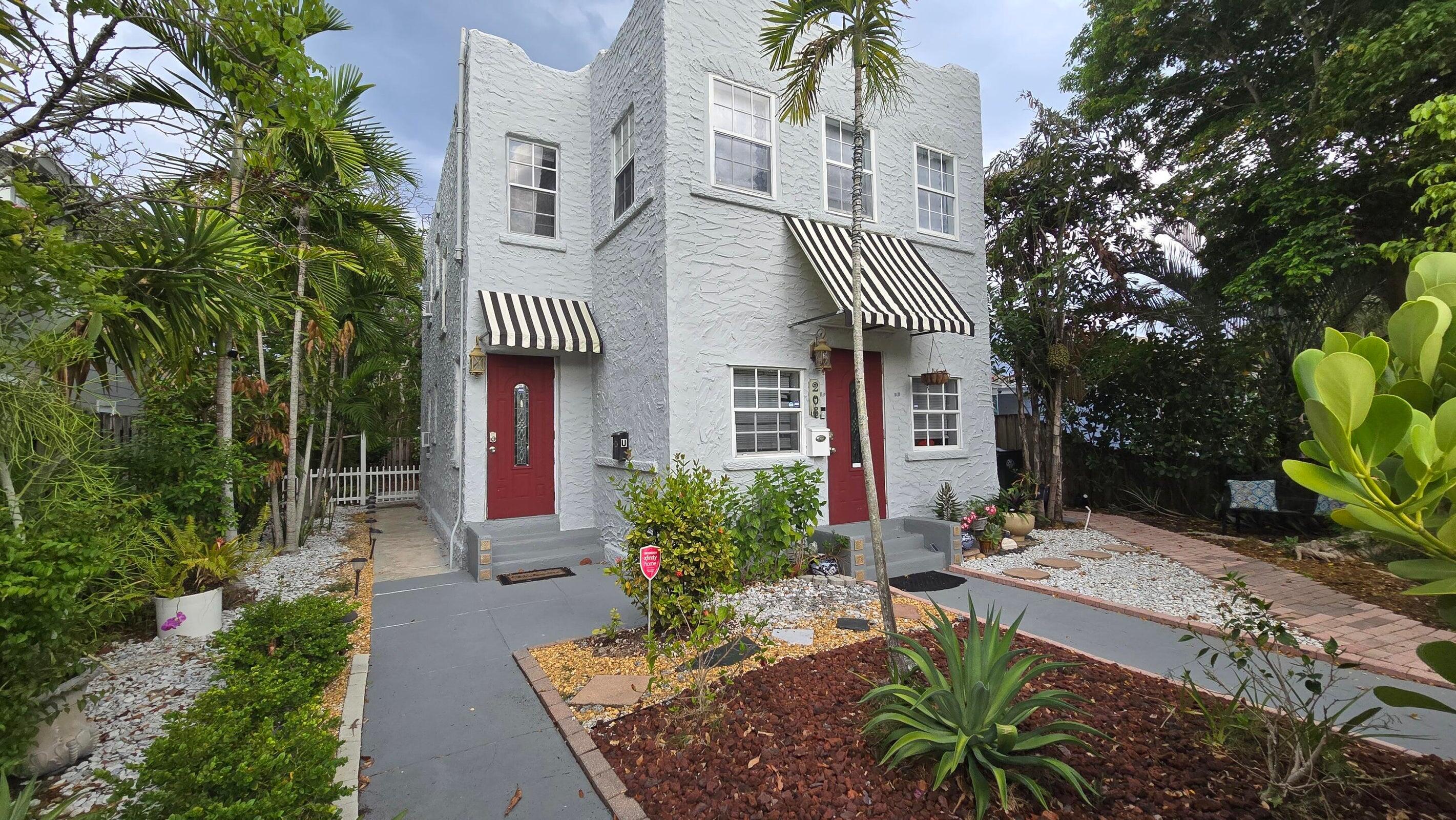 a front view of a house with a garden