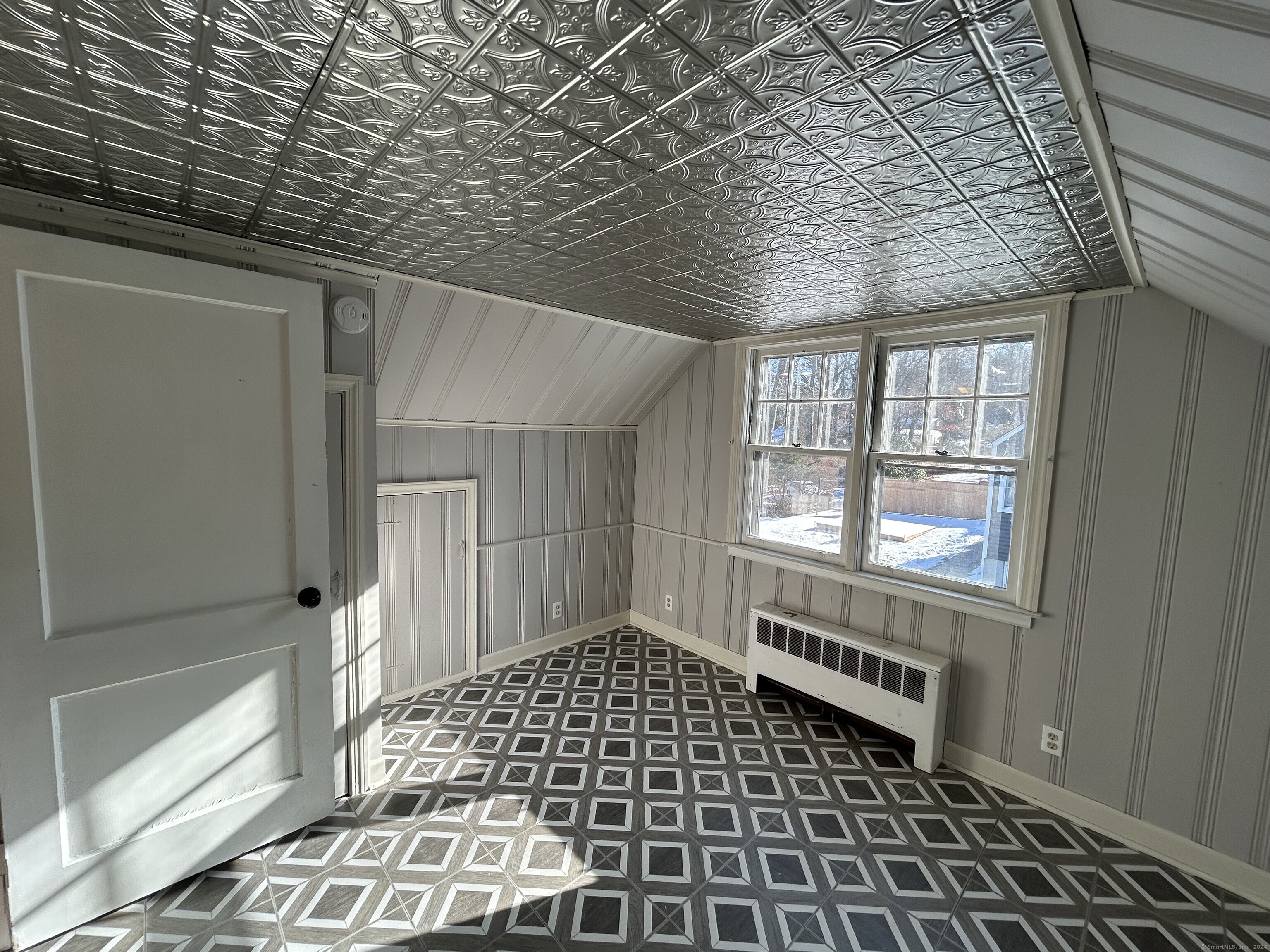 a view of a porch with wooden floor and fence