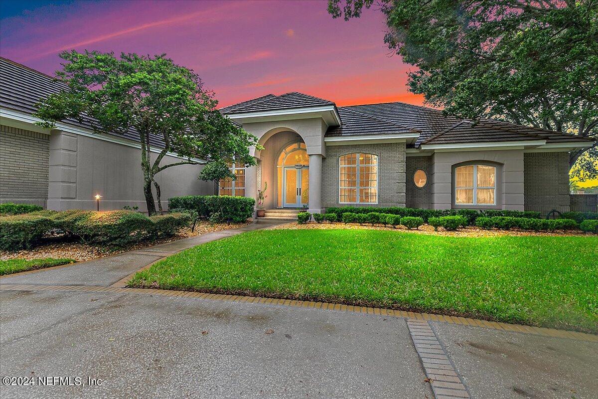 a front view of house with yard and green space