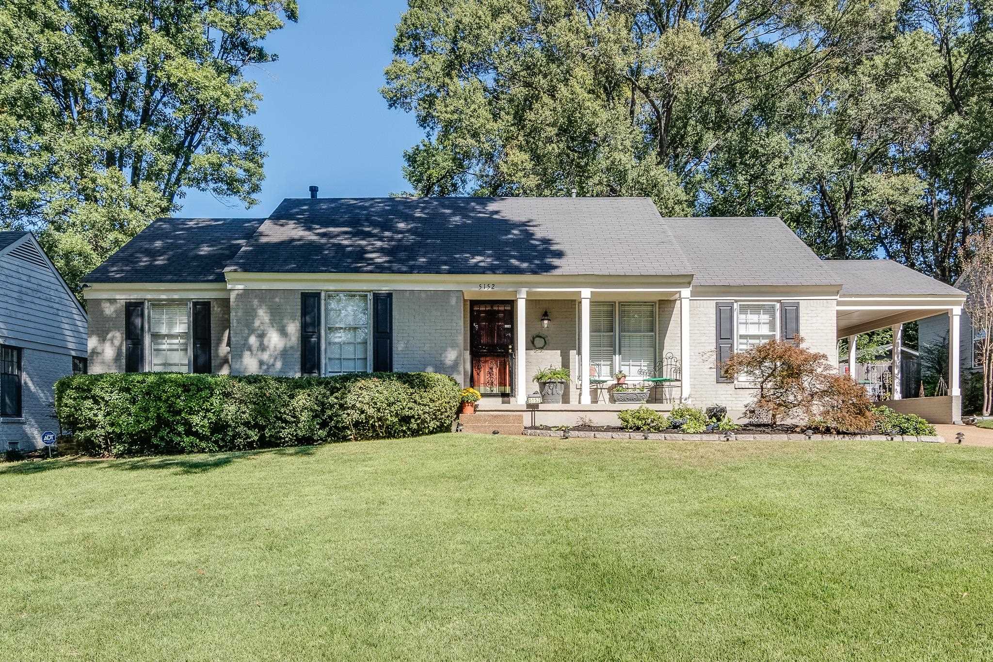 View of front of property featuring a porch and a front lawn