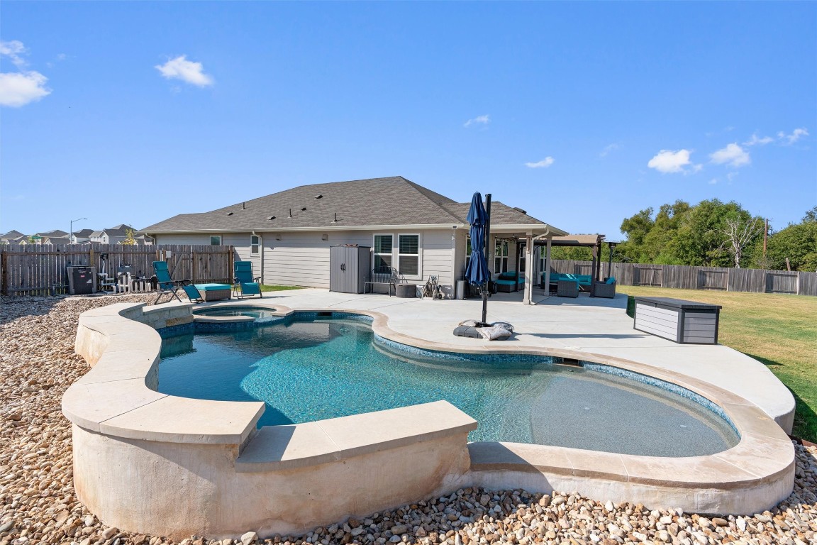 a view of a house with swimming pool and sitting area