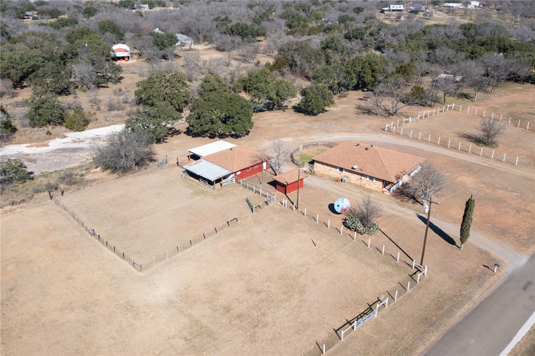 an aerial view of a house with a yard and sitting area