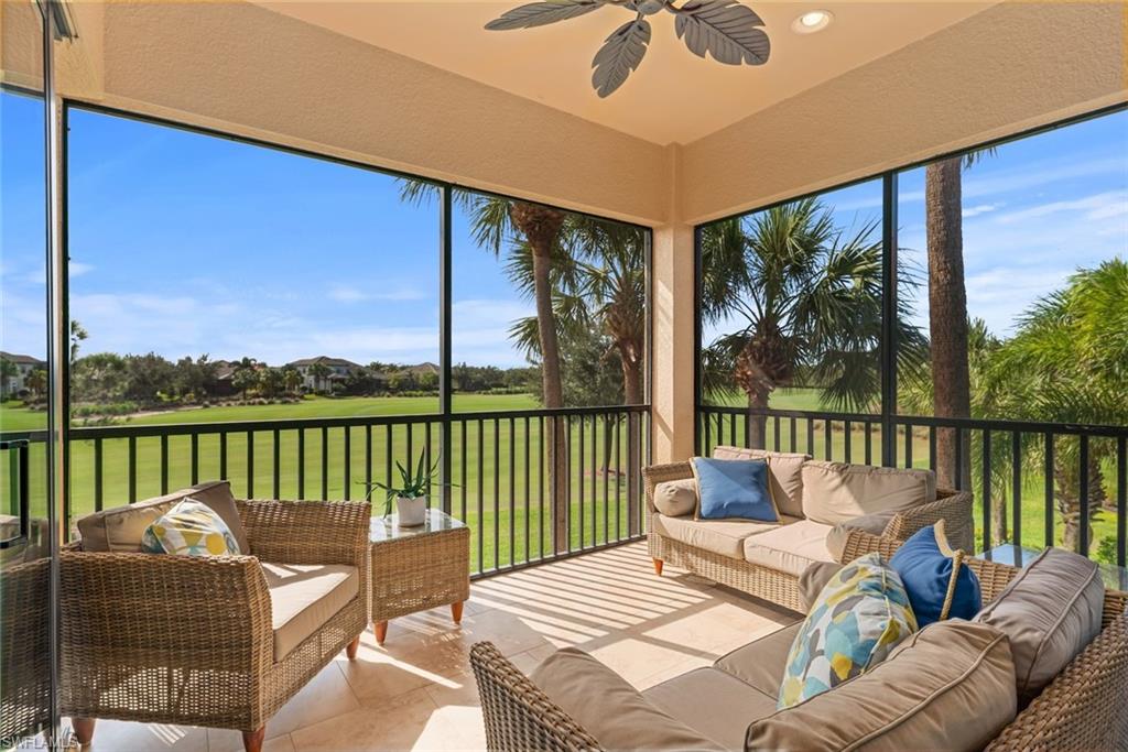 a balcony with furniture and a floor to ceiling window