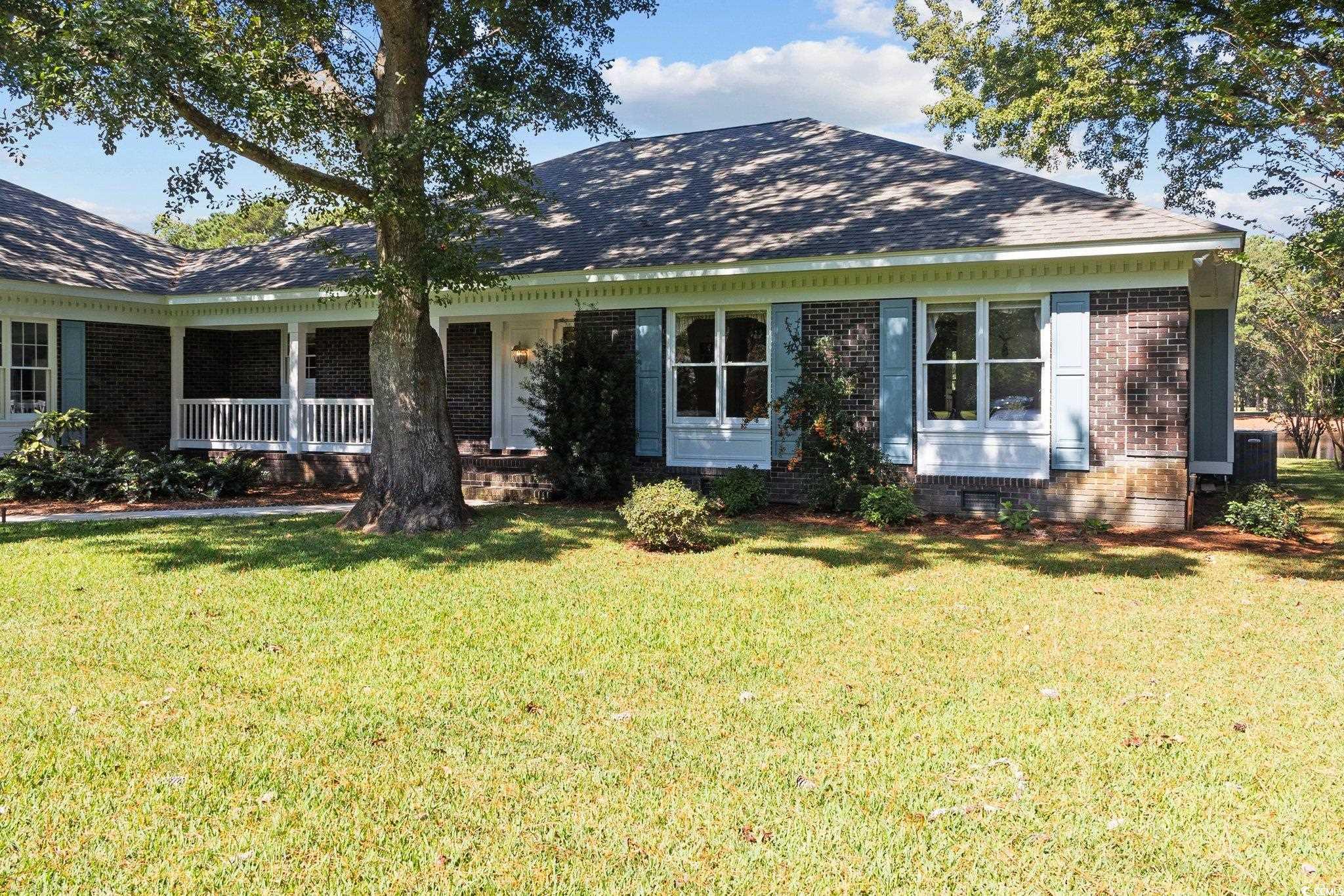 View of front of home featuring a front yard and c