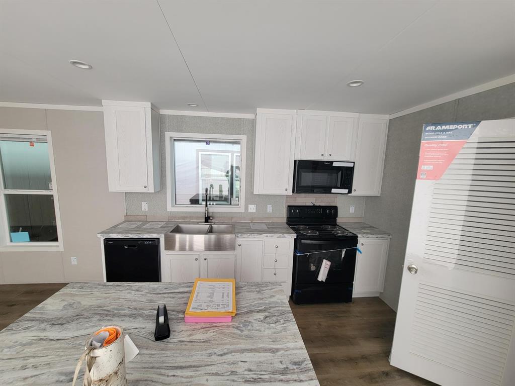 a kitchen with a sink and a stove top oven