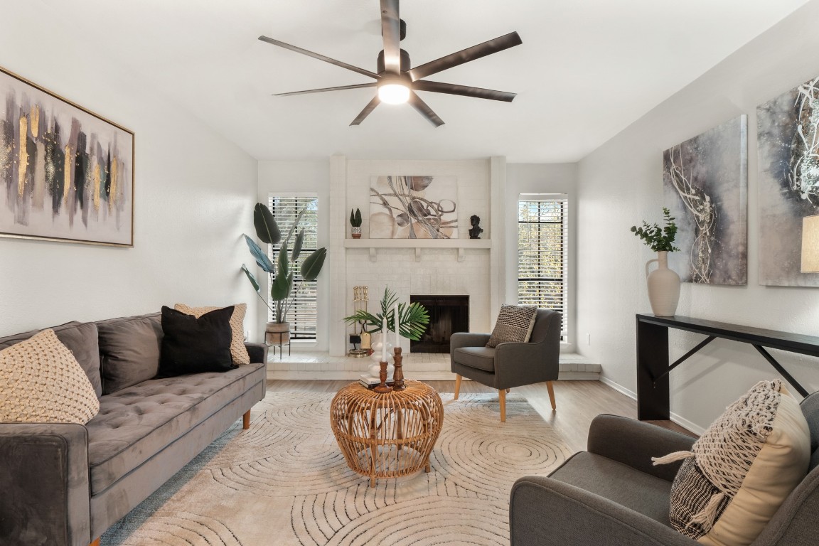 a living room with furniture a fireplace and a flat screen tv