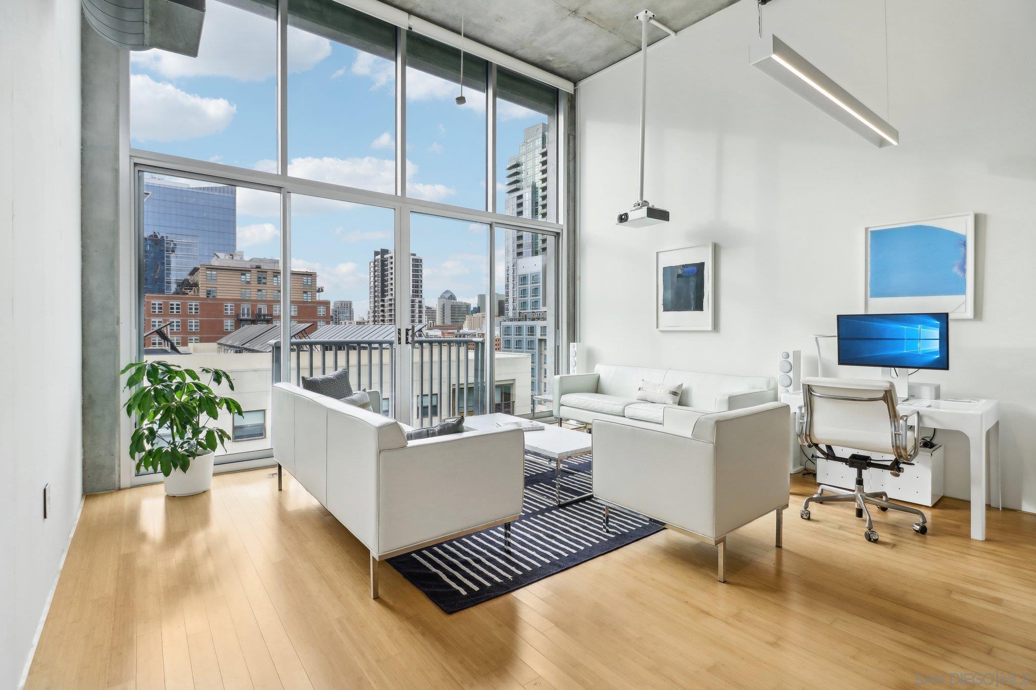 a living room with furniture and a potted plant