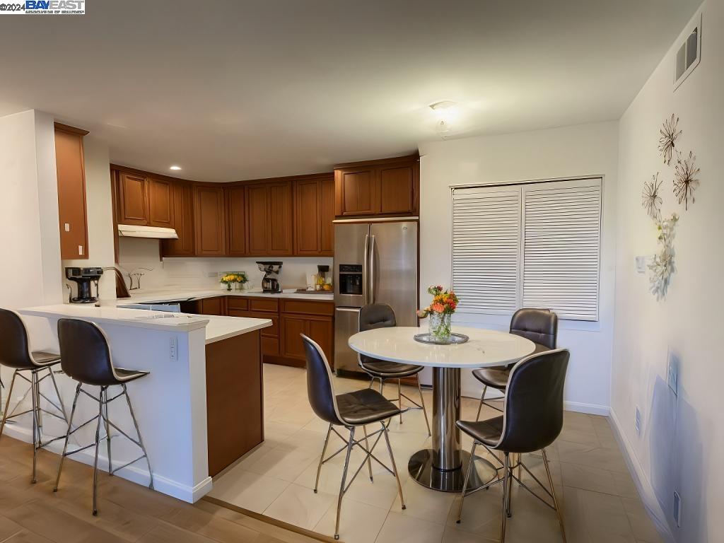 a kitchen with granite countertop sink cabinets dining table and chairs