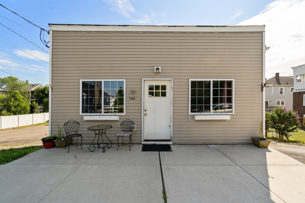 a brick house with a bench in front of it