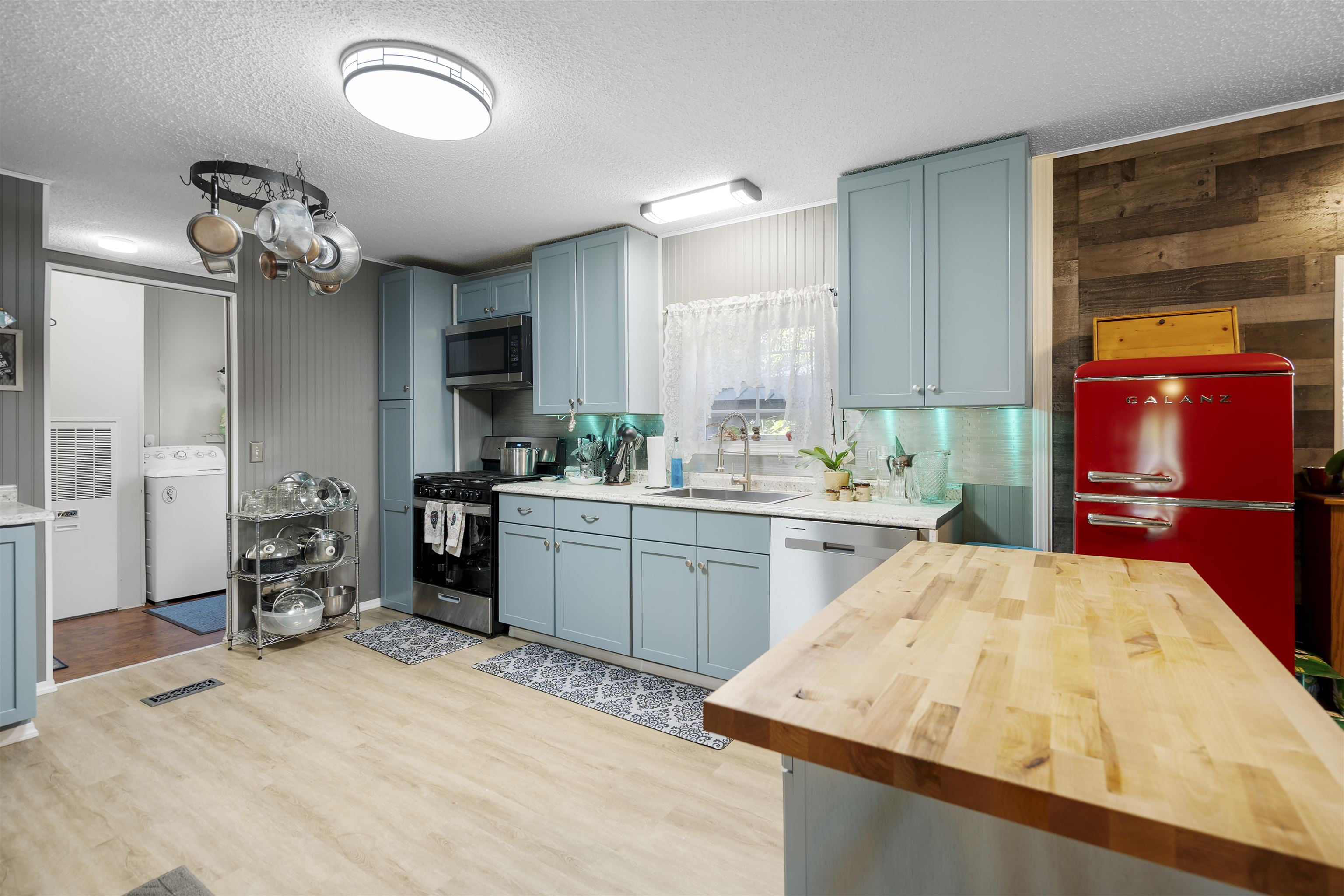 a kitchen with a sink appliances and cabinets