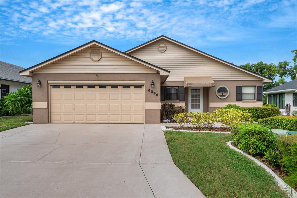 a front view of a house with a yard and garage