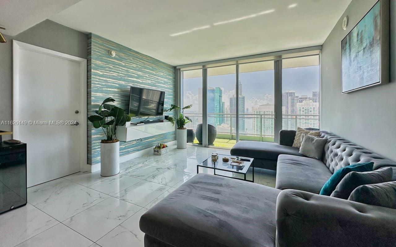 a living room with furniture and a flat screen tv