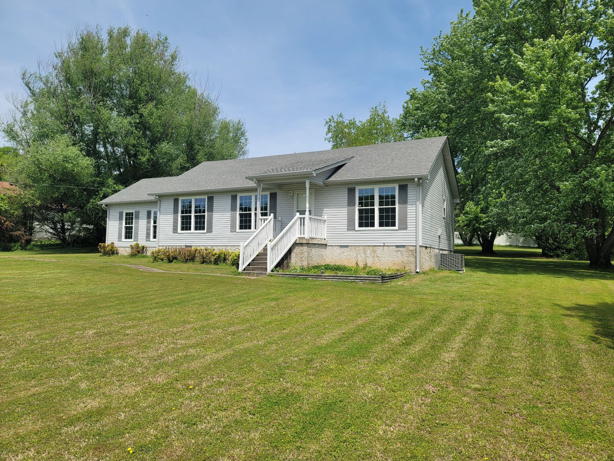 a front view of house with yard and green space