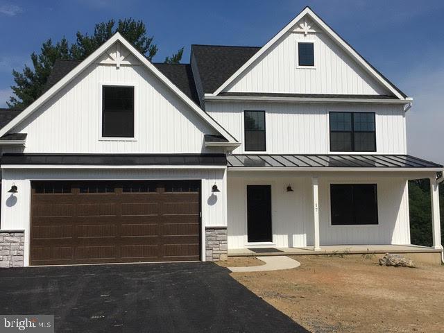 a front view of a house with garage