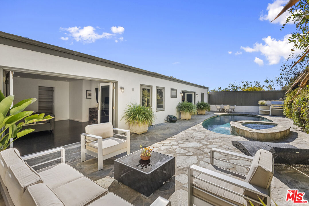 a view of a patio with couches and potted plants