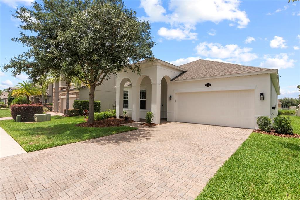 a front view of a house with a yard and garage