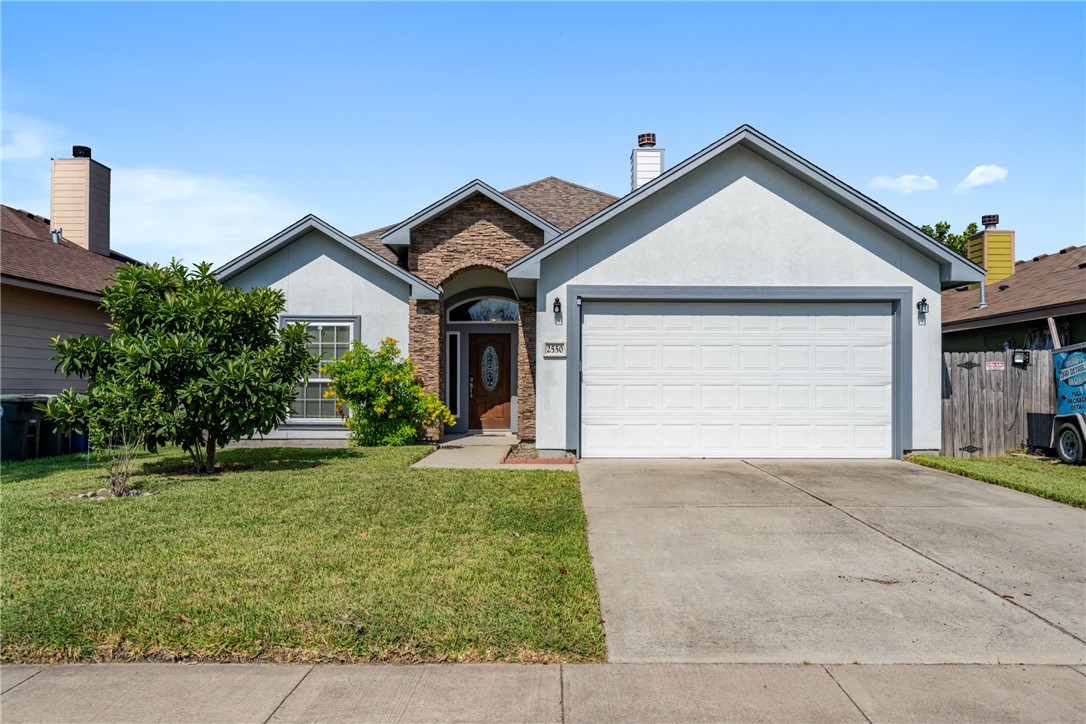 a front view of a house with a yard and garage