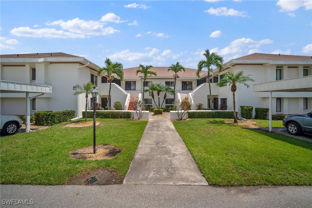 a front view of house with yard and green space