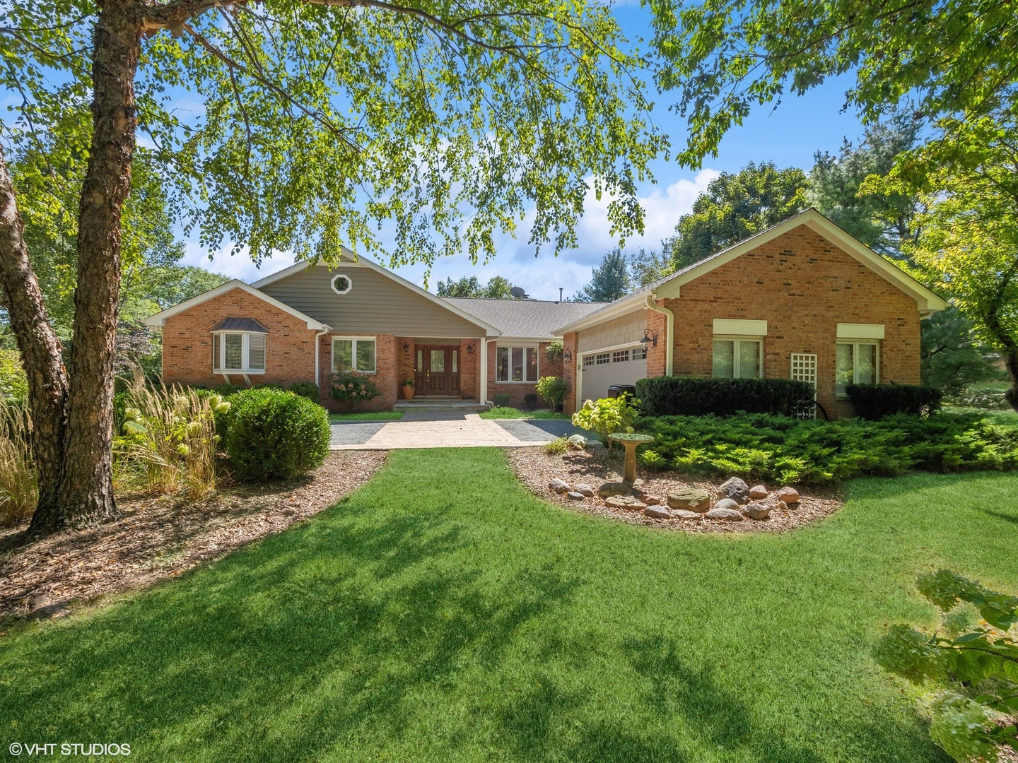 a front view of a house with a garden