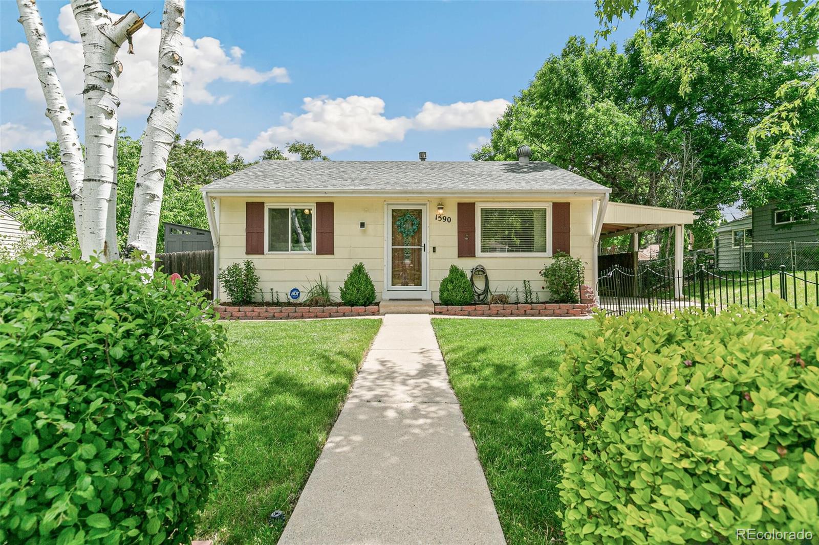 a front view of a house with garden