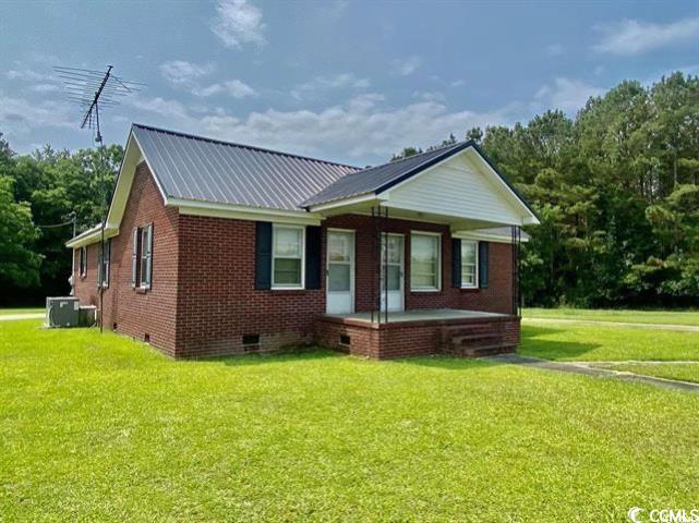 View of front of property with central AC, a porch