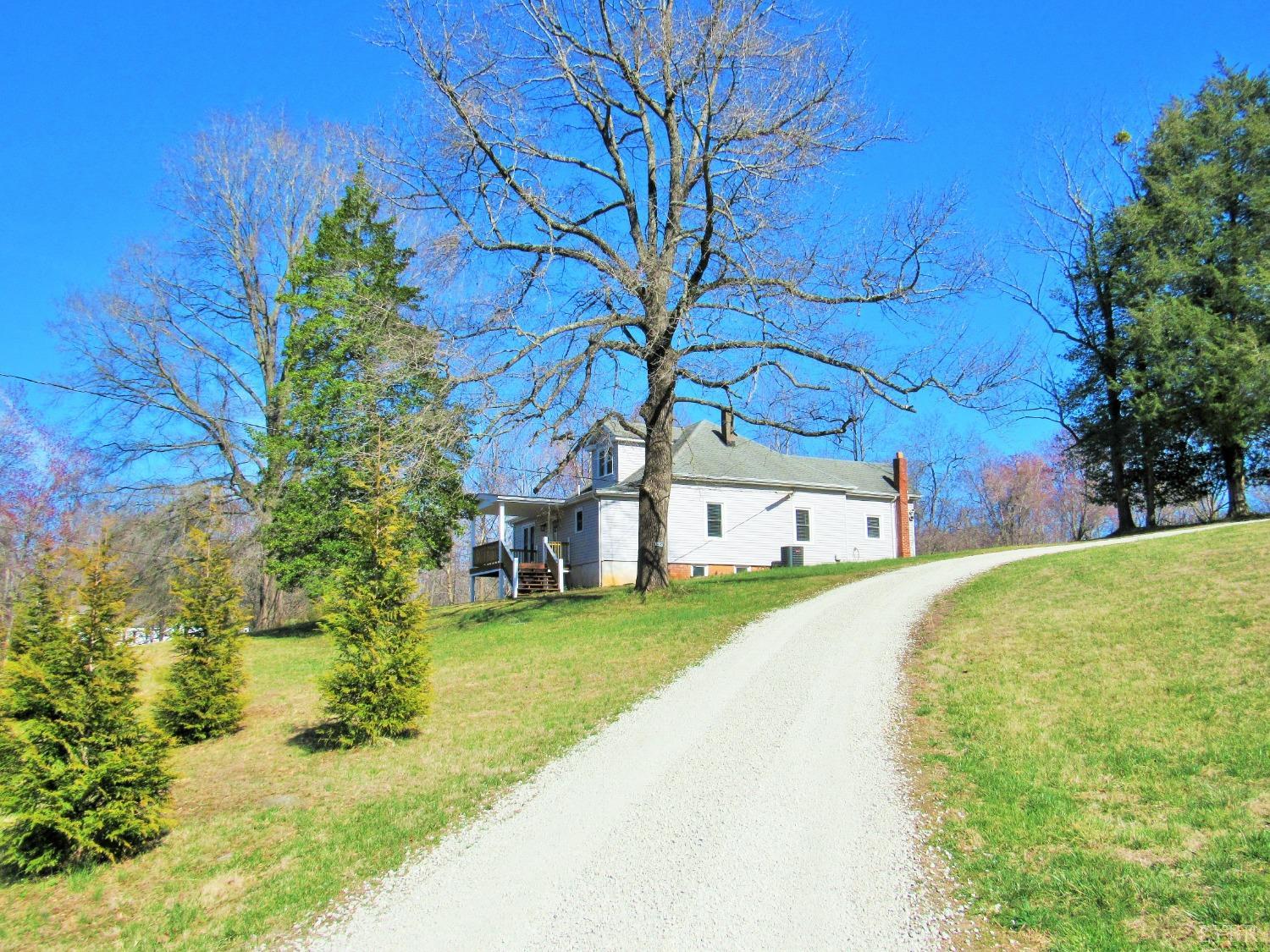 a yellow house with trees in front of it