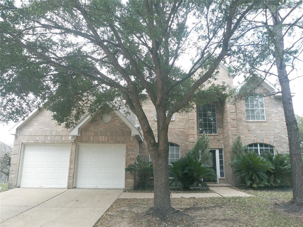 a front view of a house with yard and trees