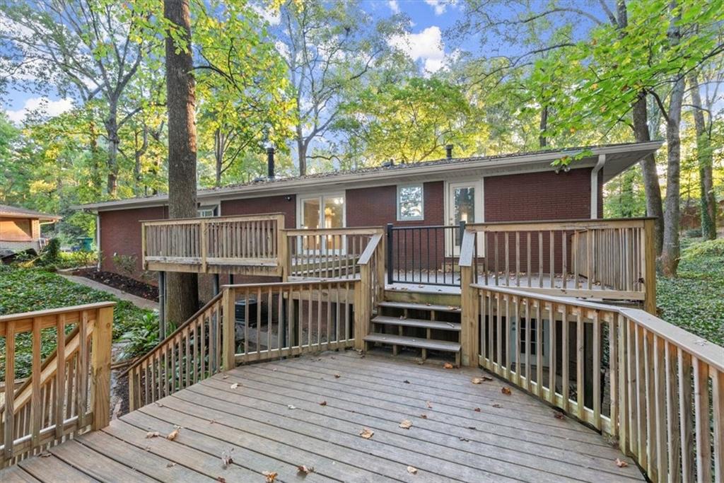 a view of a wooden deck and a backyard