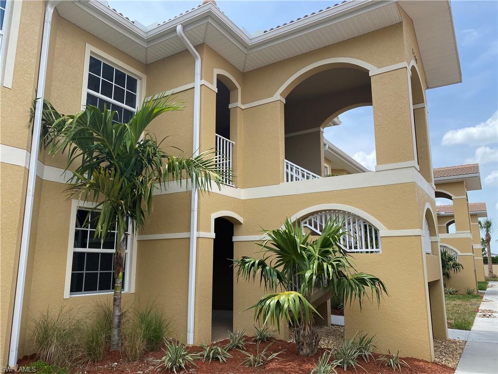 a front view of multi story residential apartment building with entryway